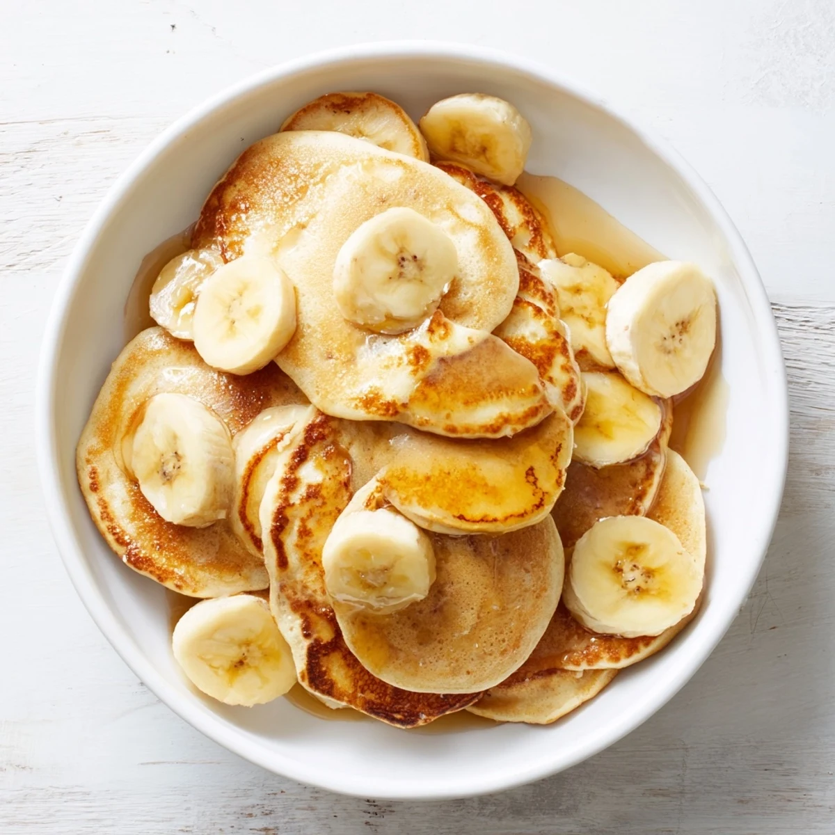 Golden Weekend Banana Pancakes served warm, drizzled with maple syrup for a delightful brunch.