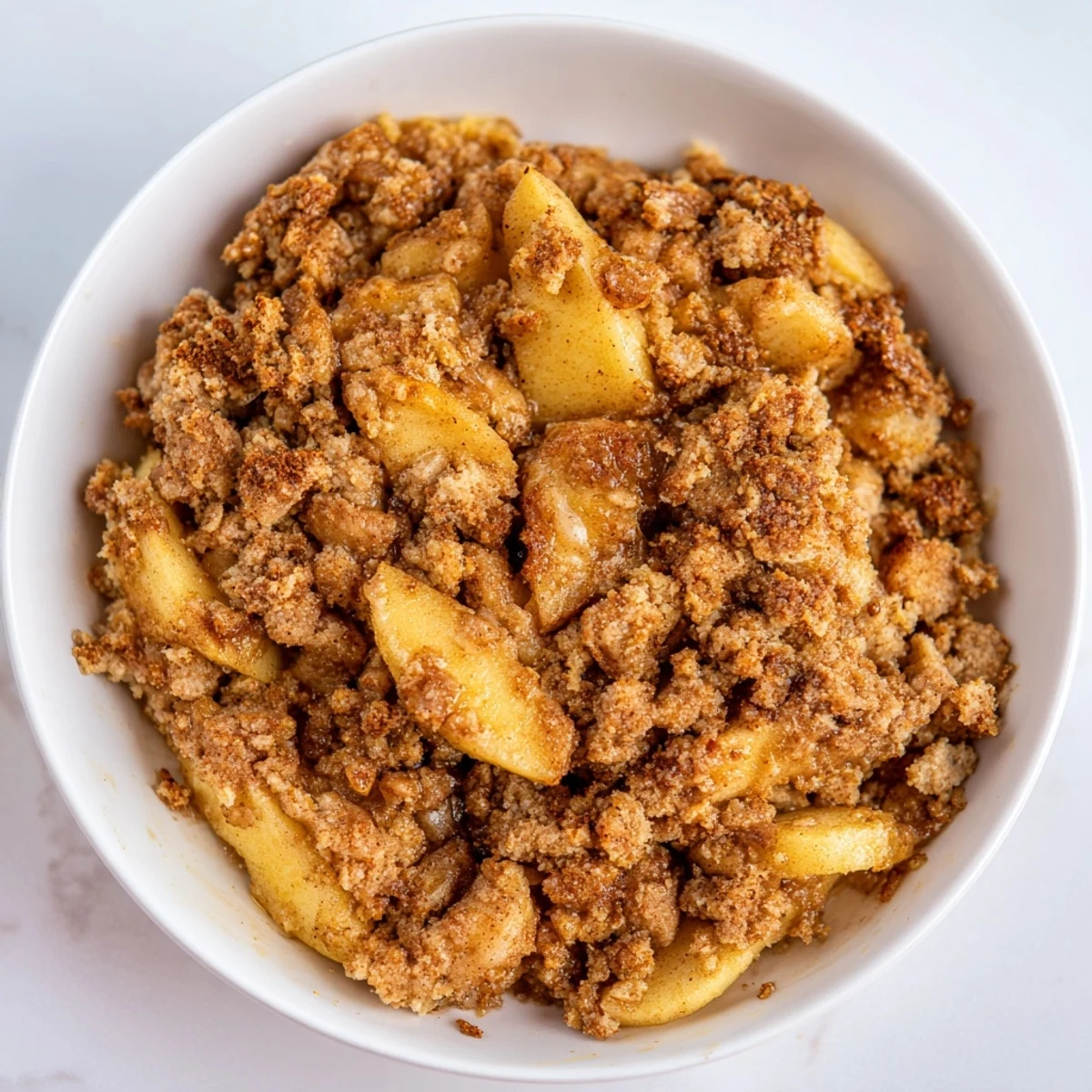 Golden brown Warm Rustic Apple and Cinnamon Crumble, bubbling and ready–a sweet treat for dessert tonight.