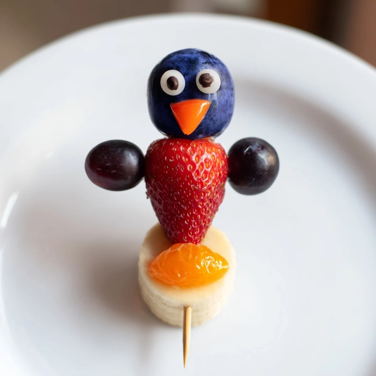 Vibrant Penguin Fruit Skewer Army featuring plump grapes, strawberries, and blueberries perfect for a kid's treat.