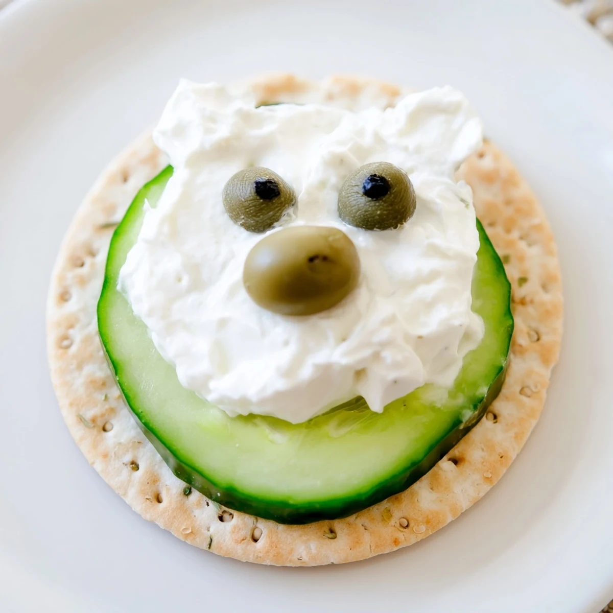 Creamy Polar Bear Iceberg Cracker Stacks sit atop crackers with caper eyes ready to enjoy.