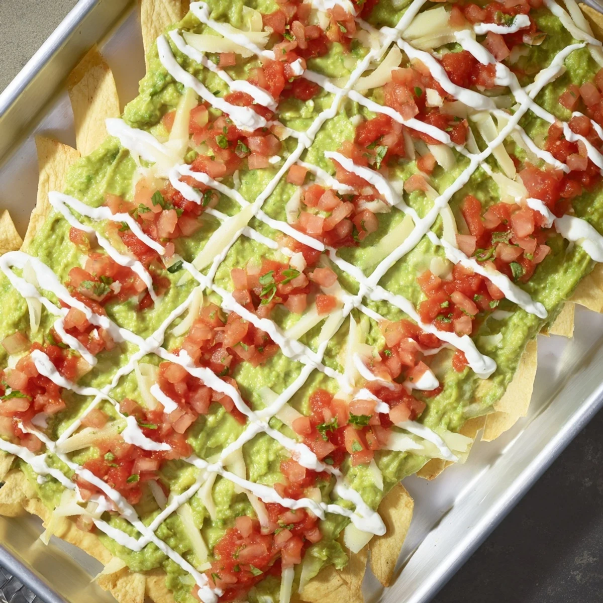 The delicious Game Day Football Field Snack Board is overflowing with chips, veggies, and savory dips.