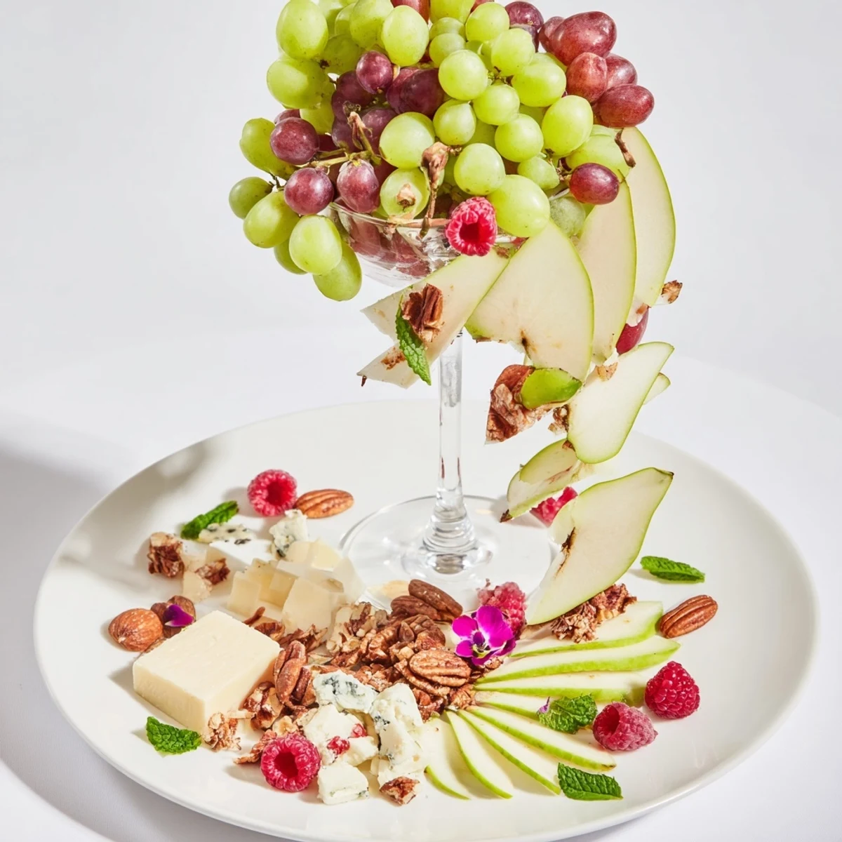 Champagne Waterfall Board overflowing with red grapes, cheese, and meats, perfect for any gathering.