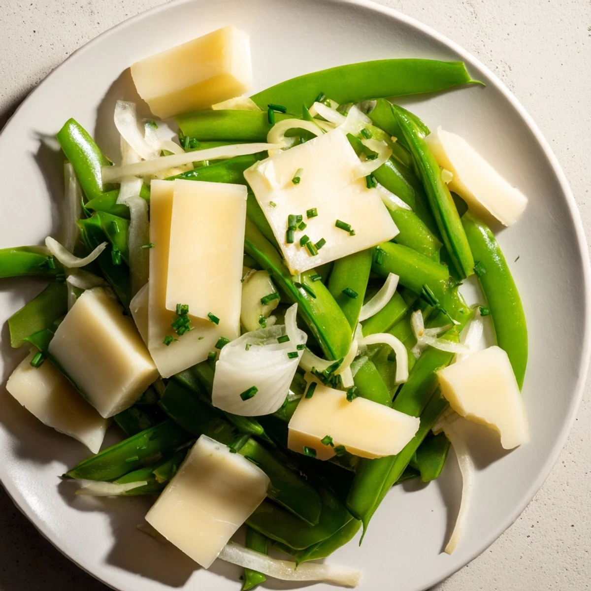 Fresh and vibrant English Ivy salad, featuring green snap peas, a beautiful vegetarian dish.