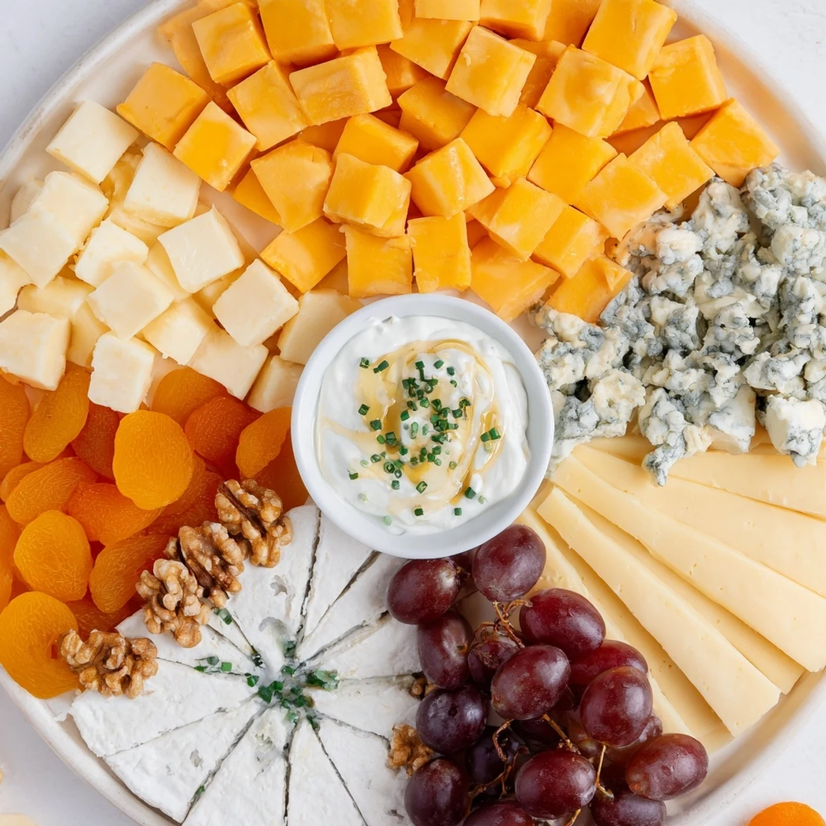 Enjoy the visually stunning The Celtic Cross Cheese Platter with brie, crackers, and a creamy central dip.