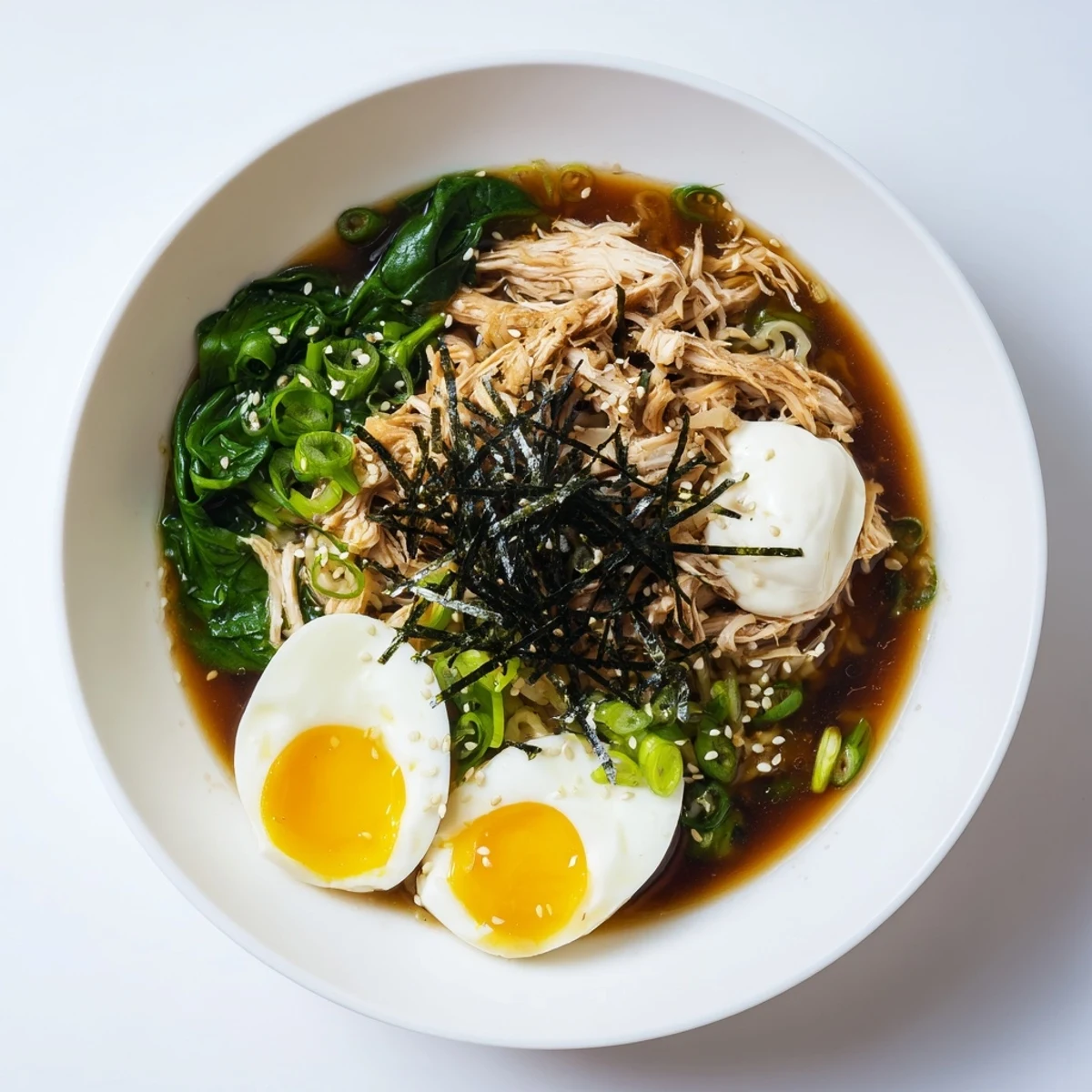 Steaming bowl of Chicken Ramen with Kewpie Mayo, topped with soft egg and scallions for a quick meal.