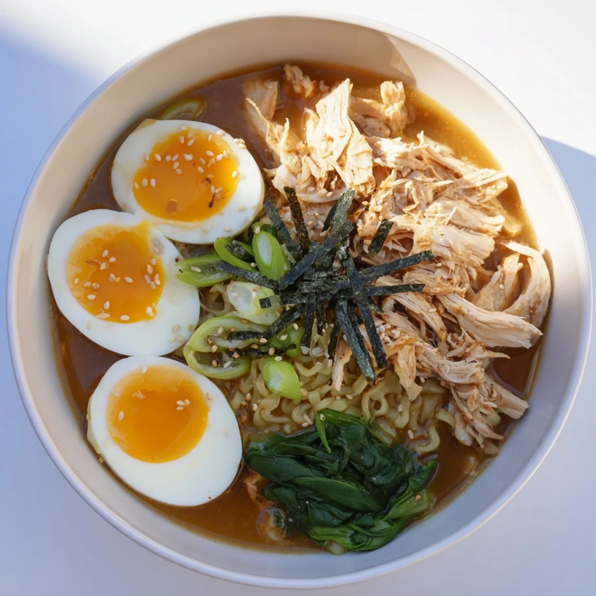 A close-up shot of delicious Chicken Ramen with Kewpie Mayo, showcasing creamy broth and fresh toppings.