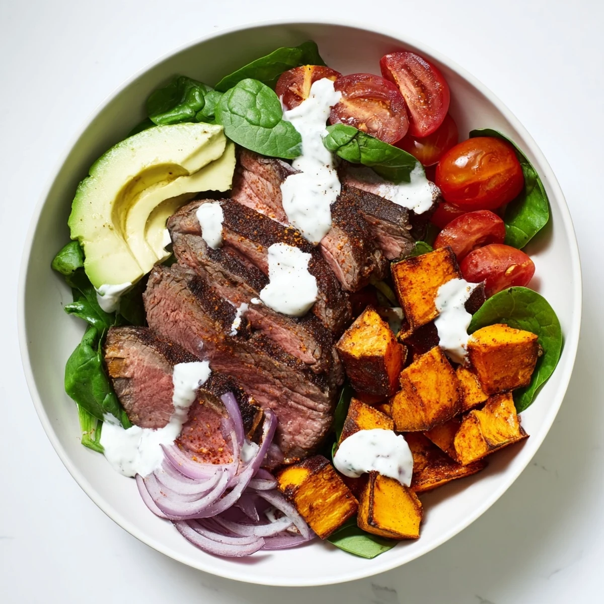 Steaming hot beef avocado sweet potato bowl with creamy avocado slices, ready to savor.