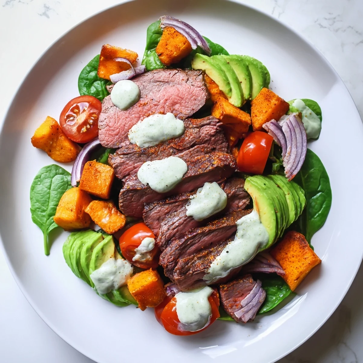 Enjoy a plated beef avocado sweet potato bowl bursting with flavors, perfect for a satisfying meal.