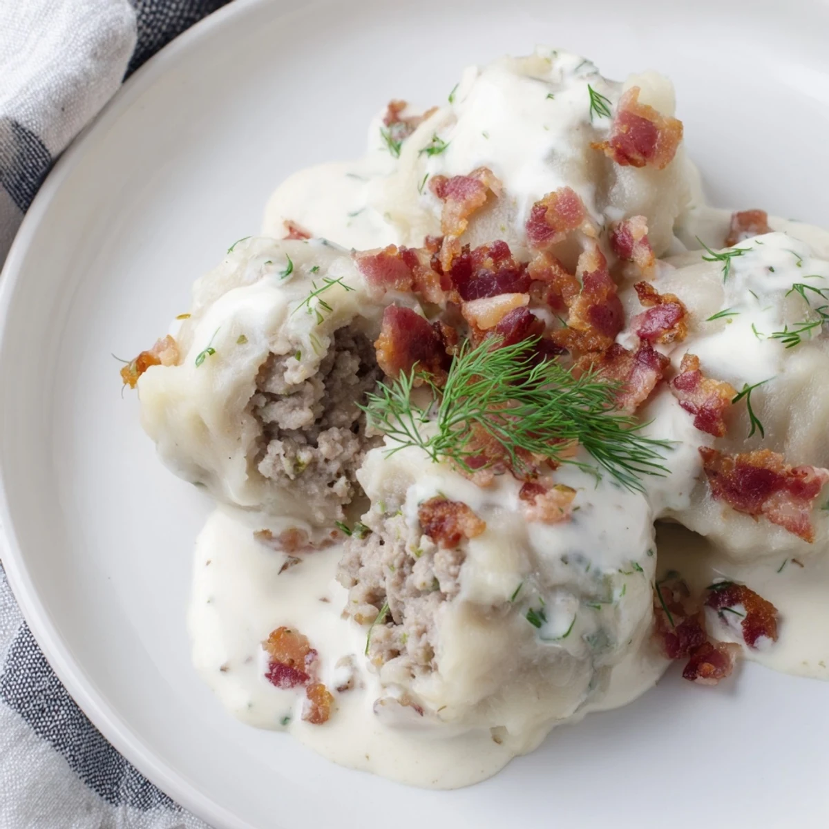 Enjoy the hearty aroma of freshly cooked Lithuanian Cepelinai, a traditional potato dumpling dish with bacon.