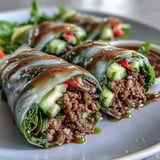 Tender ground beef and aromatic Thai basil bundled inside translucent rice paper wrappers with crunchy carrots and fresh herbs.