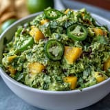 Vibrant guacamole with mango and jalapeño, perfect for festive Cinco de Mayo celebrations or as a refreshing snack.