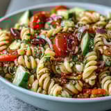 Colorful fusilli pasta salad tossed with crisp vegetables, mozzarella, and zesty Italian dressing for a refreshing side dish.  