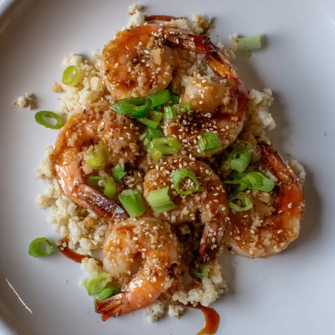 Steaming Ginger Garlic Shrimp Bowls topped with fresh green onions and sesame seeds, ready to savor.