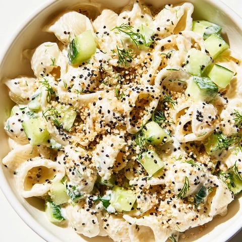 Creamy Cucumber Crunch Pasta Salad features tender shells, crisp diced cucumbers, and fresh dill on a chilled bed of tangy dressing.  