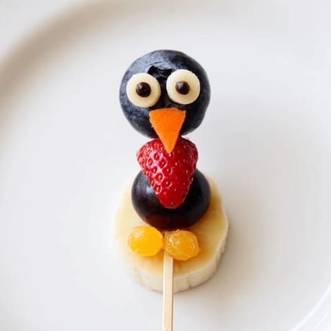 Creative Penguin Fruit Skewer Army displays colorful, fresh fruit arranged into charming penguin shapes, a fun snack idea.