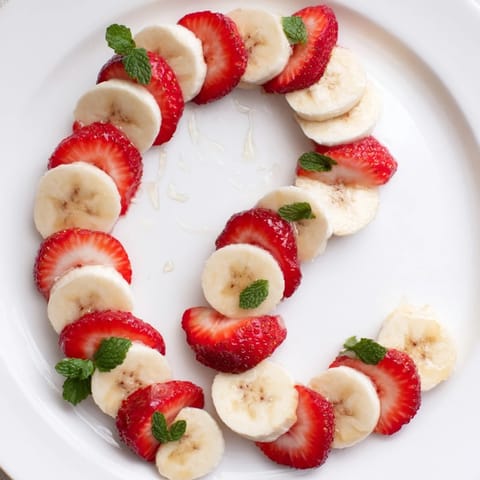 Vibrant Banana Strawberry Candy Cane: a festive, healthy snack arranged beautifully on a plate.