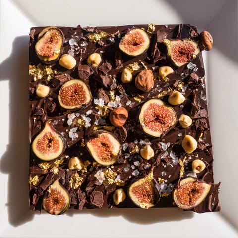 Rich, dark layers of the Midnight Mosaic dessert with a scattering of cocoa nibs.