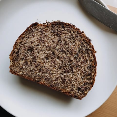 Picture this: a warm Estonian Leib sourdough loaf, ready to be sliced for a delicious meal.