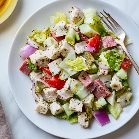 Italian Deli Chopped Chicken Salad served in a rustic bowl, ready for a hearty lunch with crusty bread on the side.  