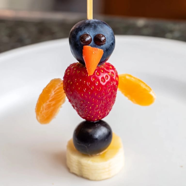 Delicious and healthy Penguin Fruit Skewer Army: a visually appealing, refreshing, naturally sweet dessert perfect for parties.