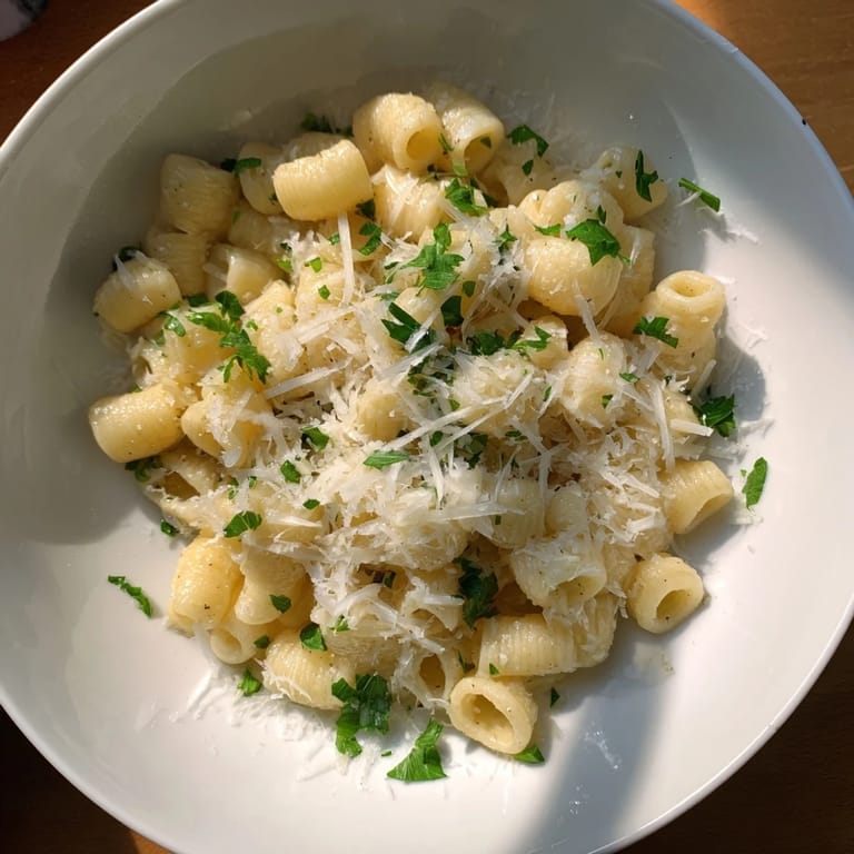 A close-up shot of the savory 15-Minute Garlic Parmesan Pasta, ready to savor, with flecks of parsley.