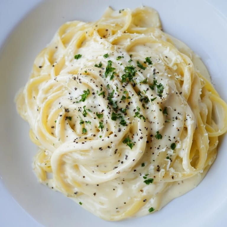 Easy Pasta Alfredo Cottage Hack features cooked pasta blanketed in a luscious, homemade, white sauce.