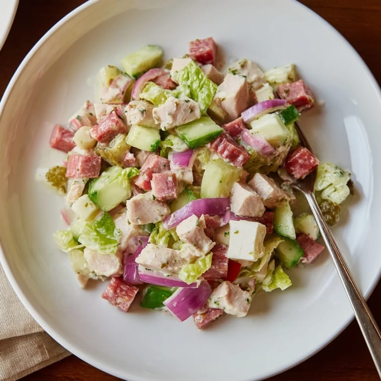 Vibrant Italian Deli Chopped Chicken Salad featuring chopped chicken, salami, and crisp romaine with a tangy oregano vinaigrette.