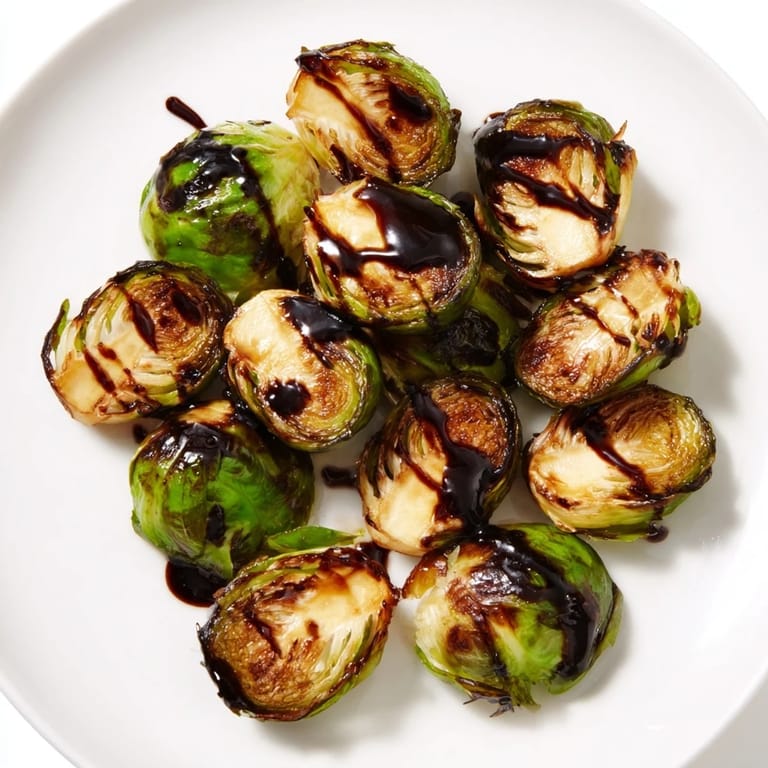 Golden-brown Roasted Brussels Sprouts With Balsamic offer a savory-sweet bite, perfect alongside roasted chicken for a weeknight dinner.